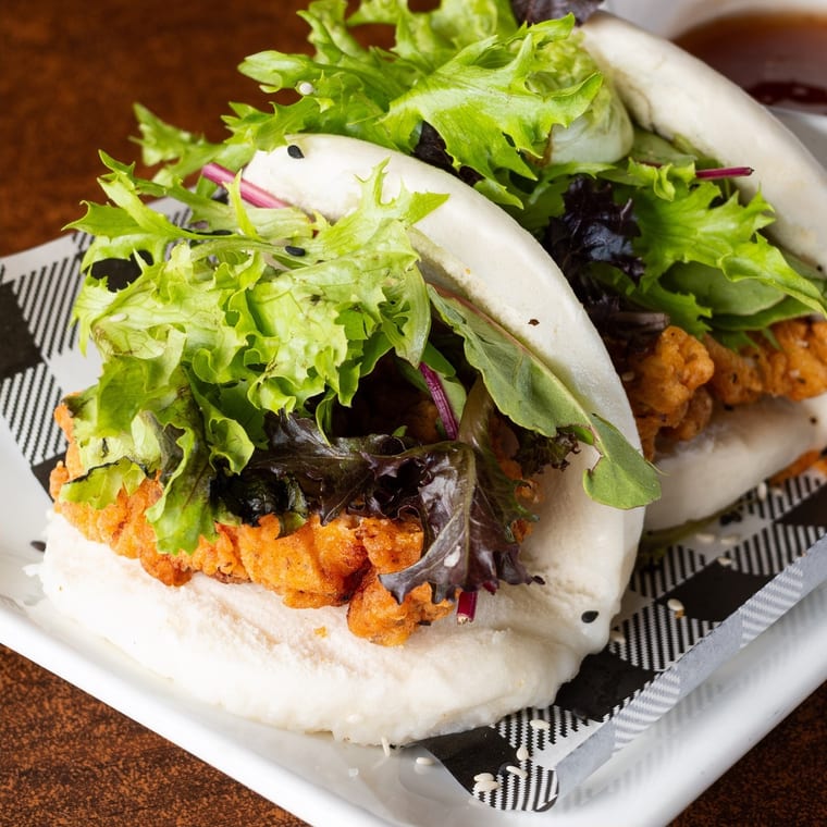 Fried chicken bao bun with fresh greens