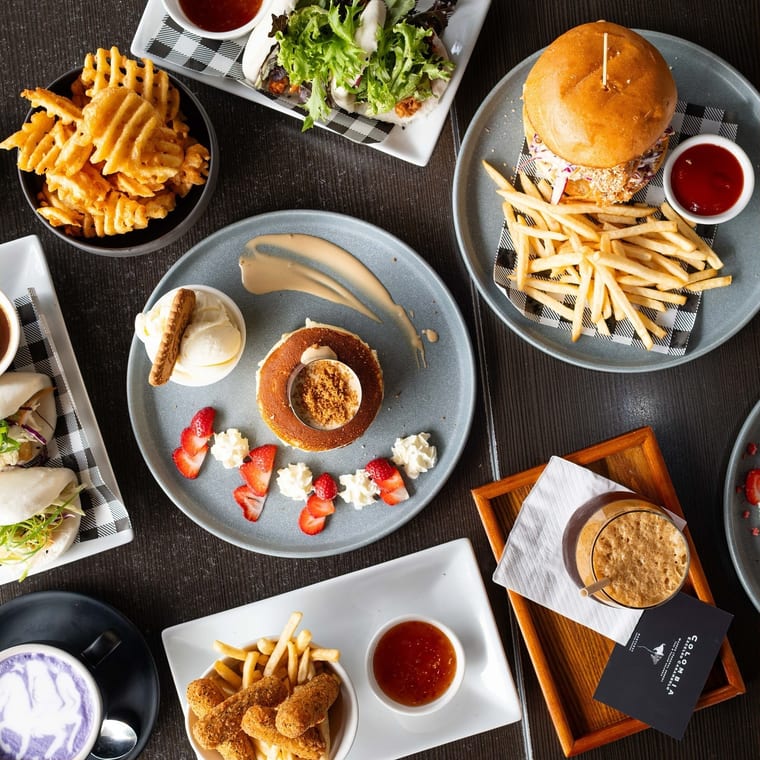 A spread of burgers, waffle fries and sweets